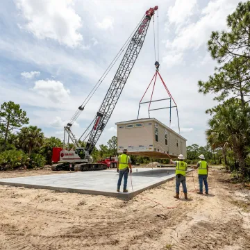 Crane setting a modular building in Florida