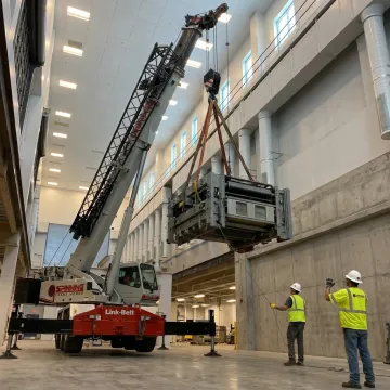 Industrial crane lifting heavy equipment in Florida