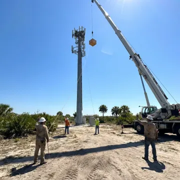 Boom crane erecting a cell tower in Florida