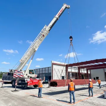 Crane lifting steel on a Florida construction site