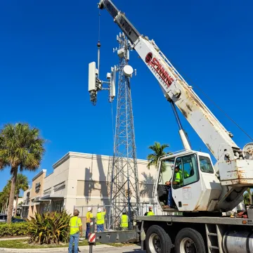Boom crane lifting rooftop equipment in Florida