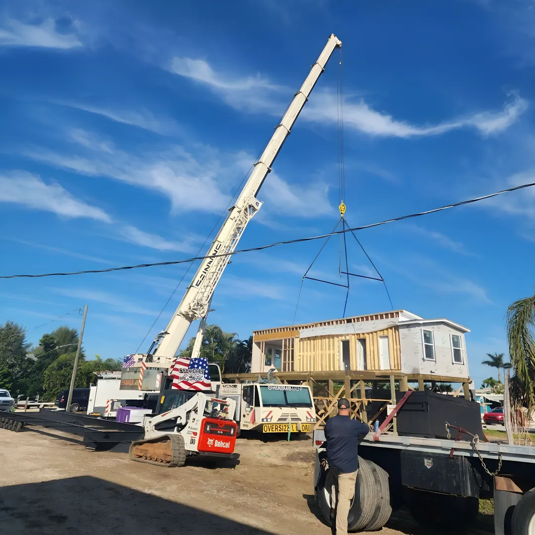Commercial crane lifting structural steel on a Florida jobsite