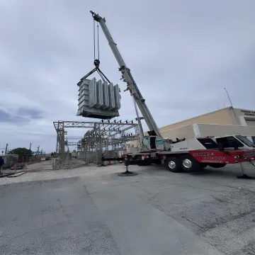 Crane removing a hurricane-damaged fallen tree in Florida