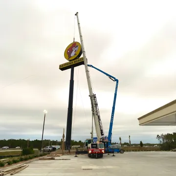 Crane operator lifting tree sections safely