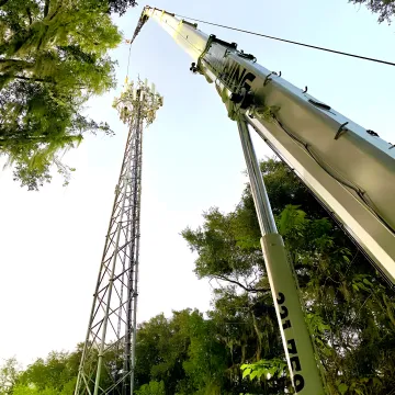 Industrial crane rigging crew lifting heavy equipment in Florida