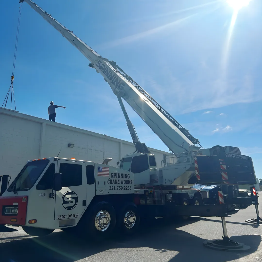 Crane lifting rooftop HVAC equipment in Florida