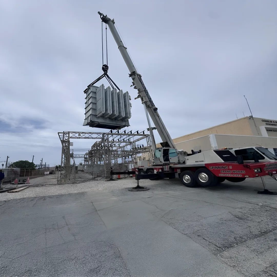 Crane lifting heavy equipment in Florida