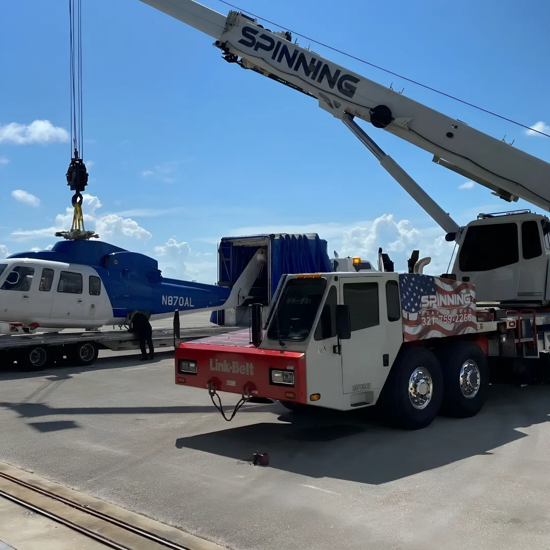 Mobile crane lifting heavy equipment in Florida