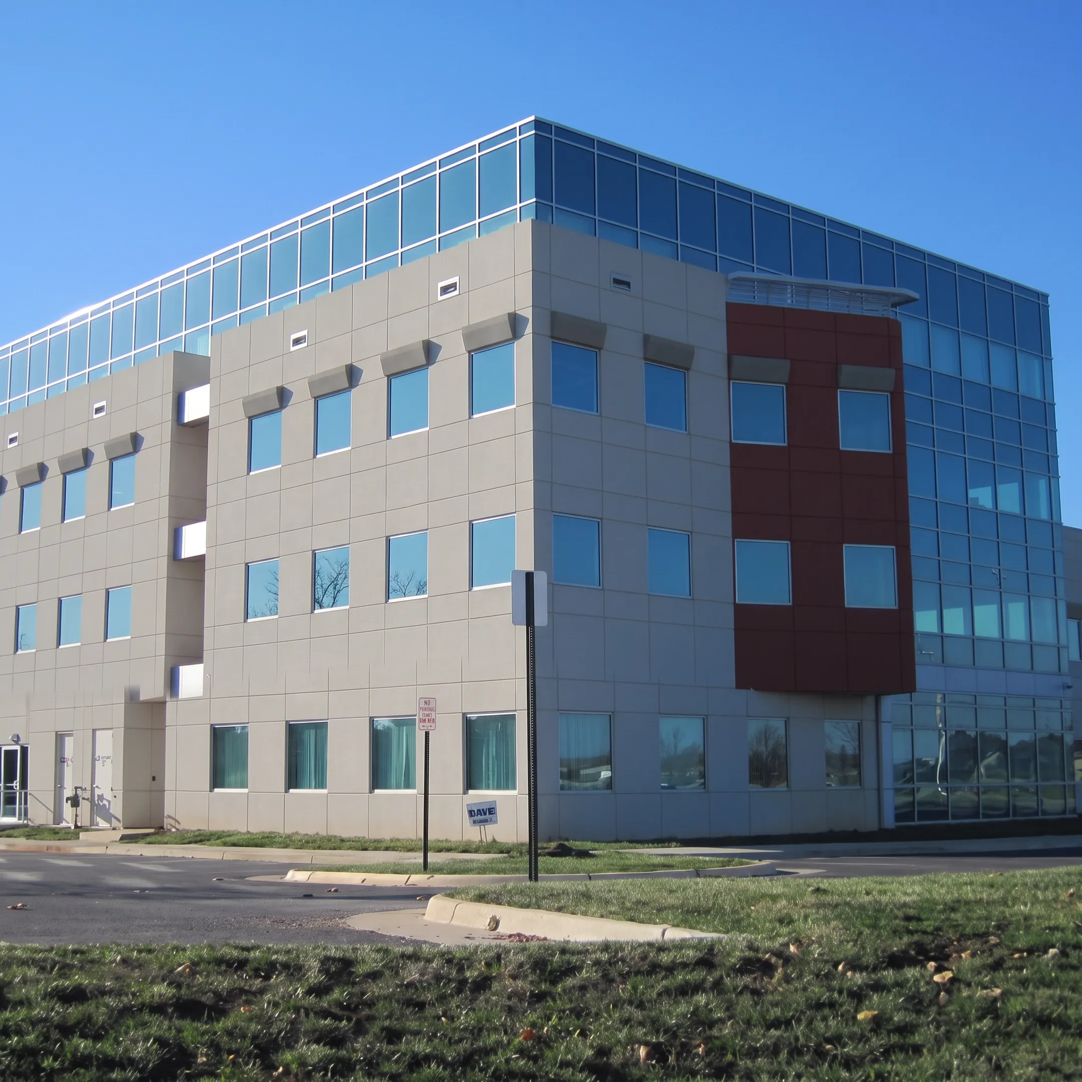 Workers applying an exterior cladding system to a commercial building