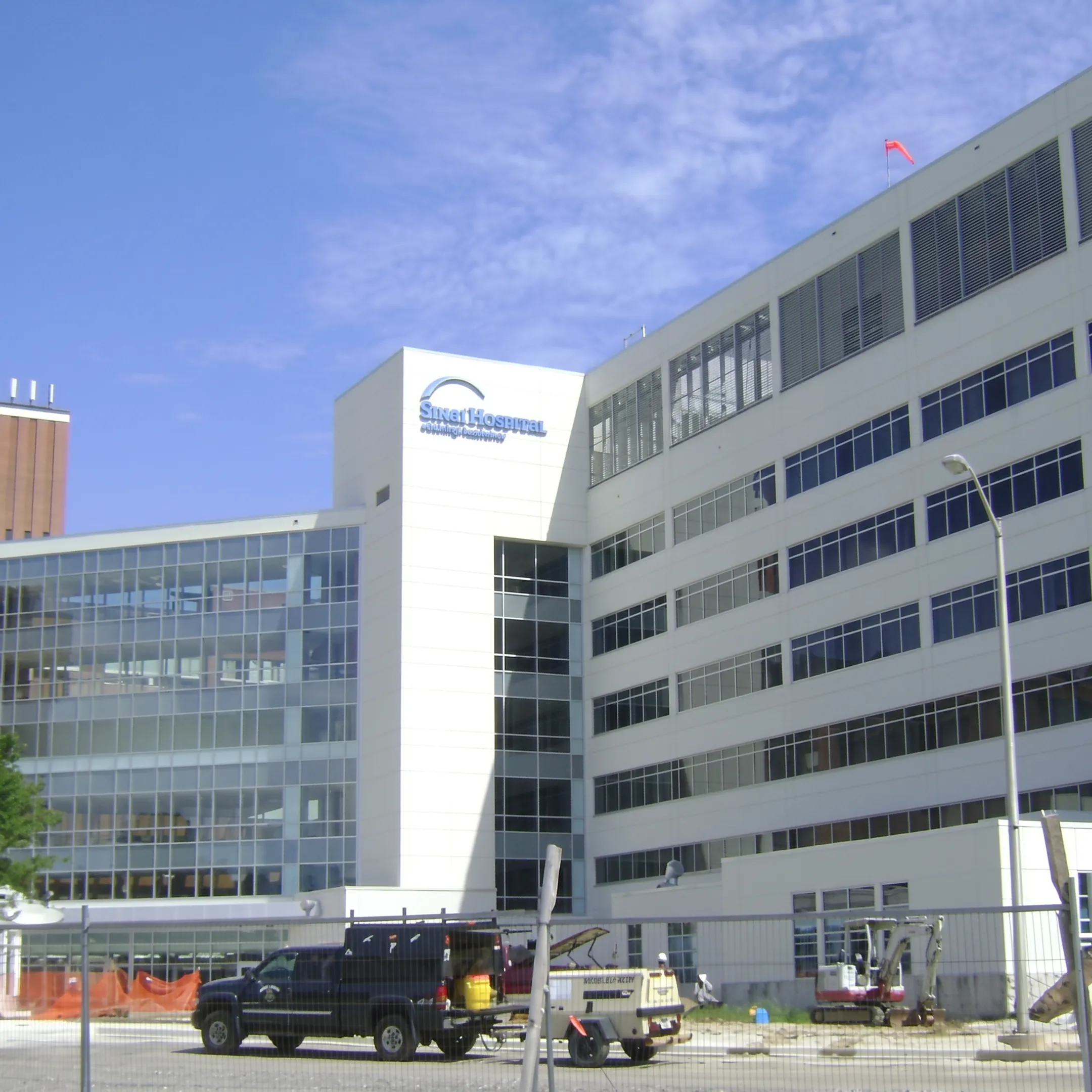 Commercial crew installing exterior wall panels on a large building