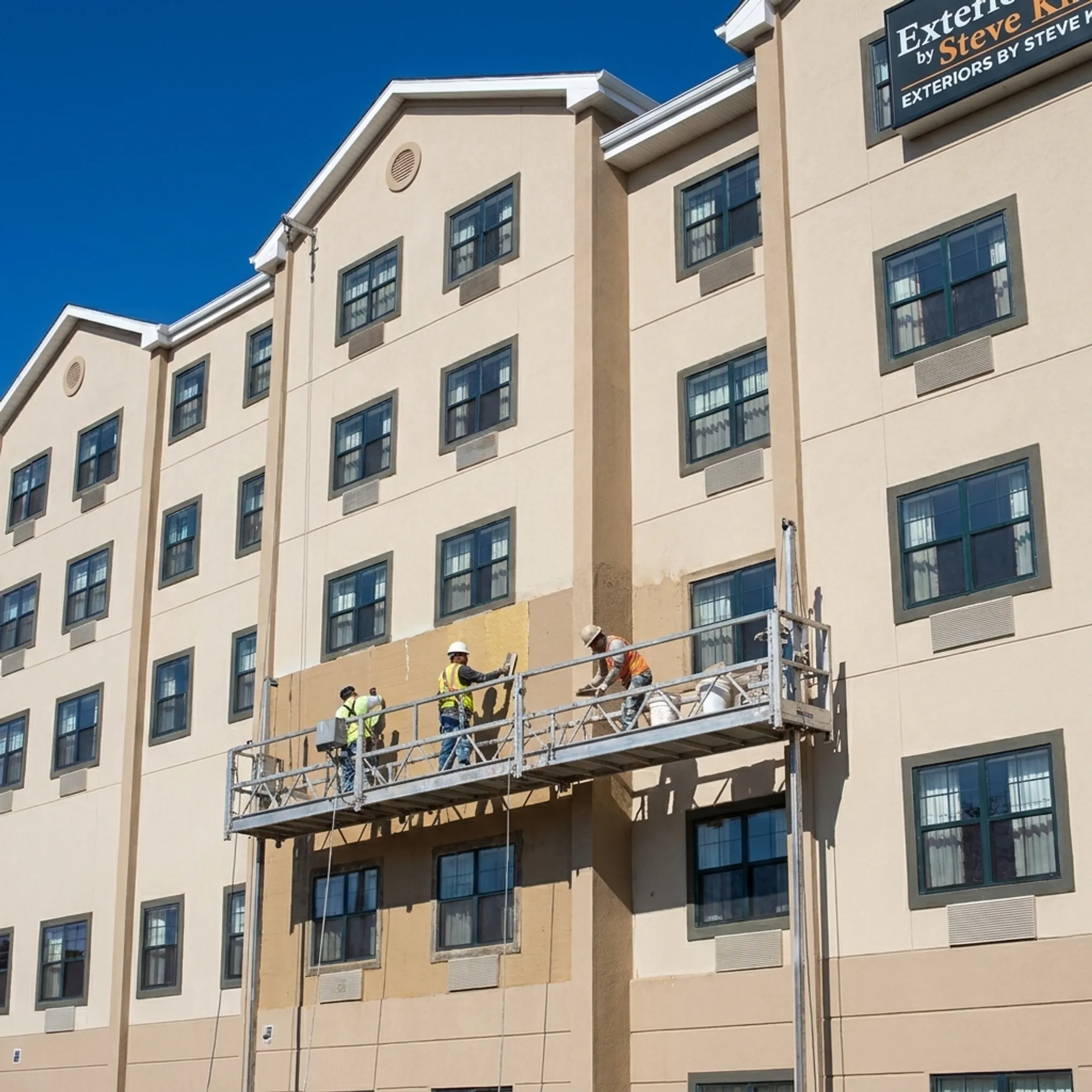 EIFS installation crew applying exterior wall finish on a Maryland commercial building