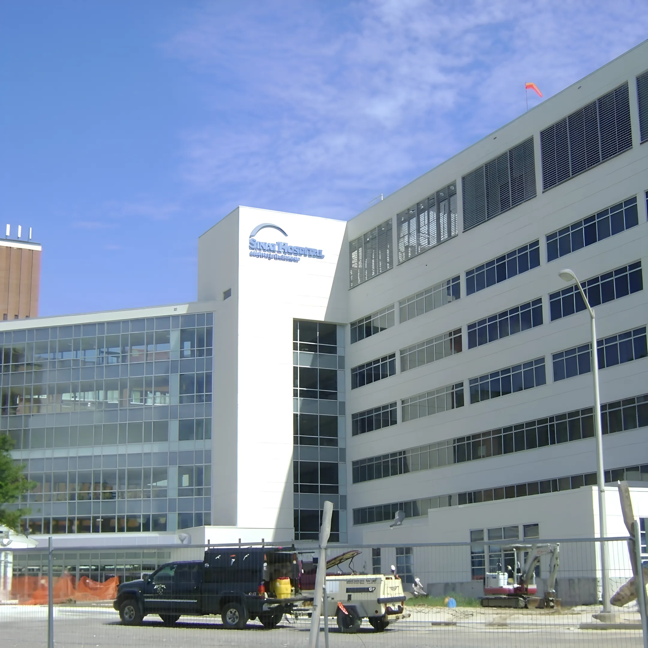 Commercial EIFS exterior being repaired and painted by a professional crew