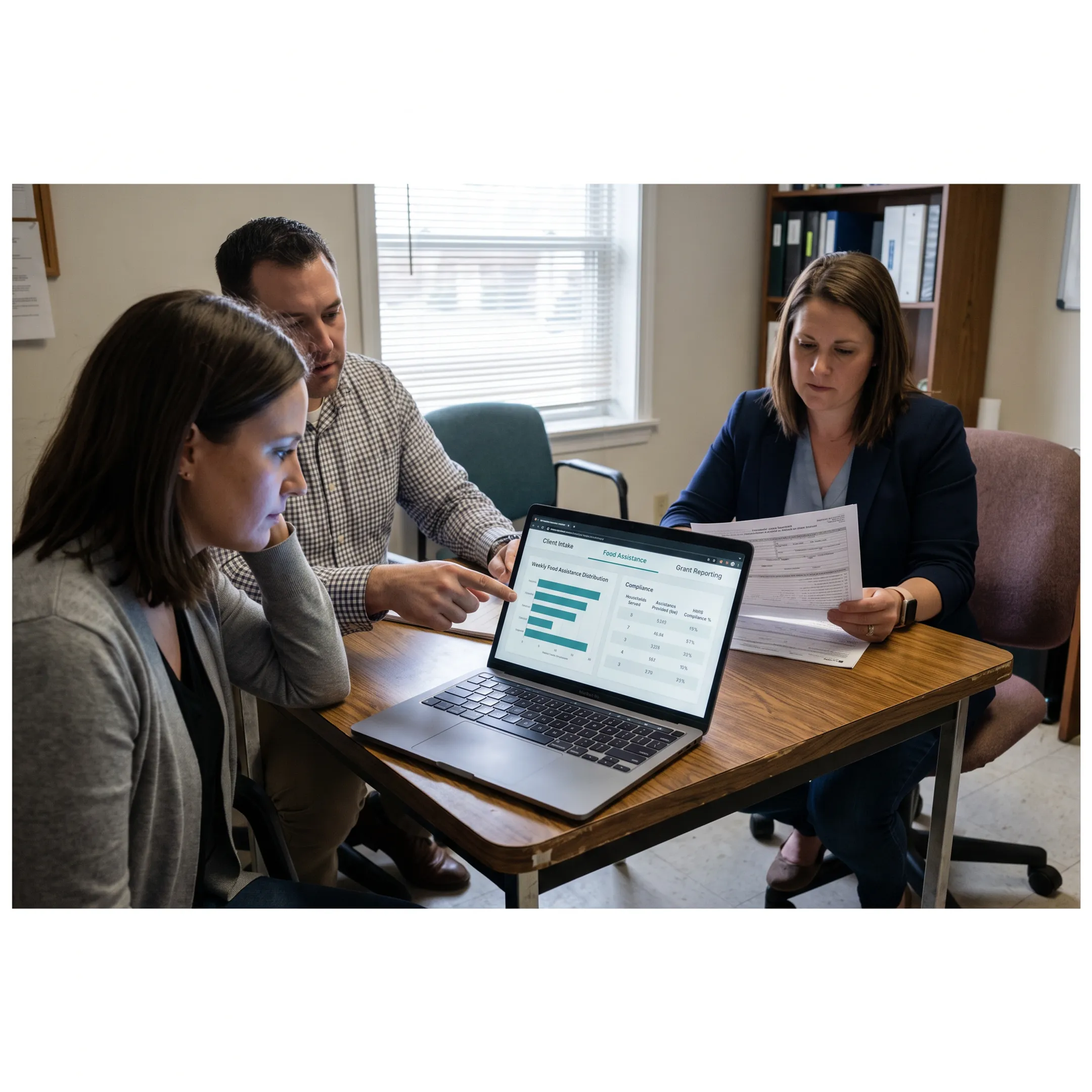 Nonprofit team reviewing centralized food assistance records and reporting dashboards