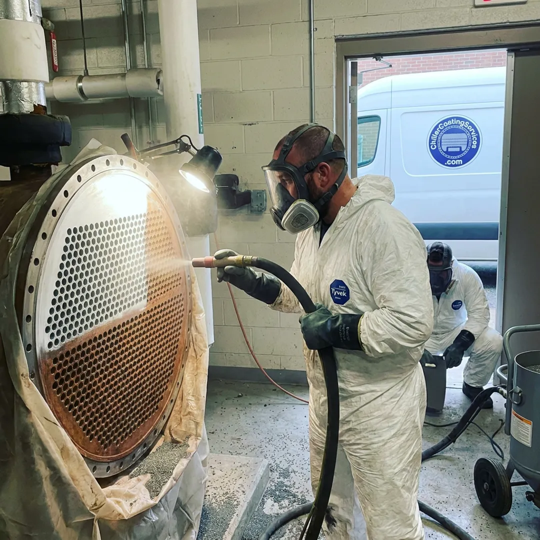 Technicians preparing hospital chiller tube sheet