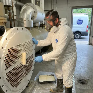 Technician coating industrial chiller tube sheet