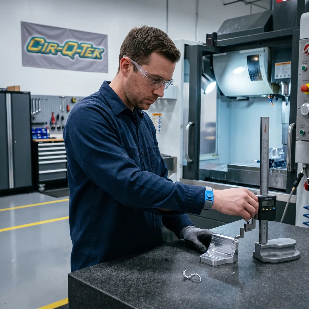 Technician inspecting a precision-machined component