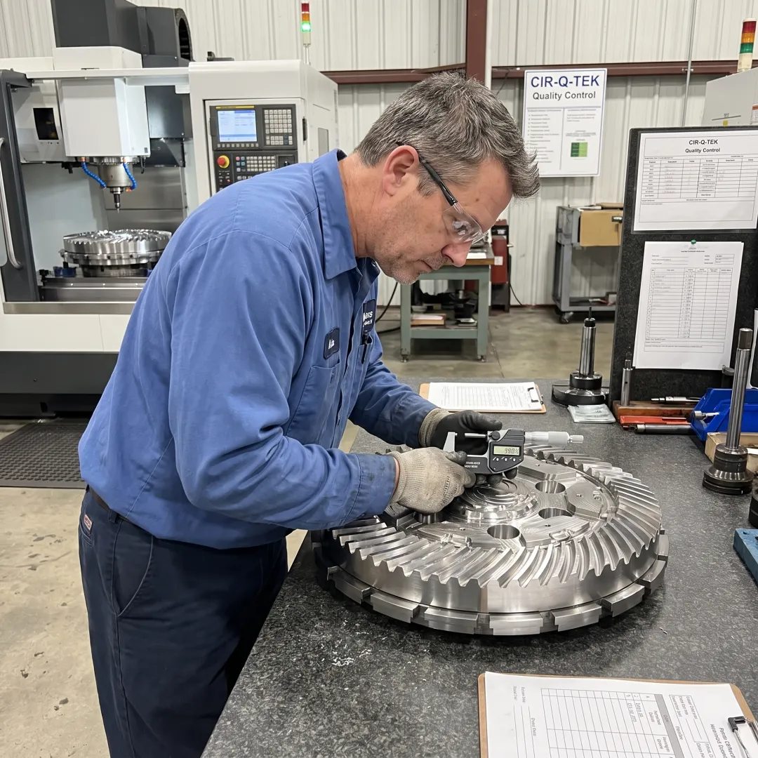 Technician inspecting a machined metal component