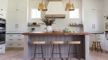Farmhouse kitchen island with butcher block wood countertop and pendant lighting