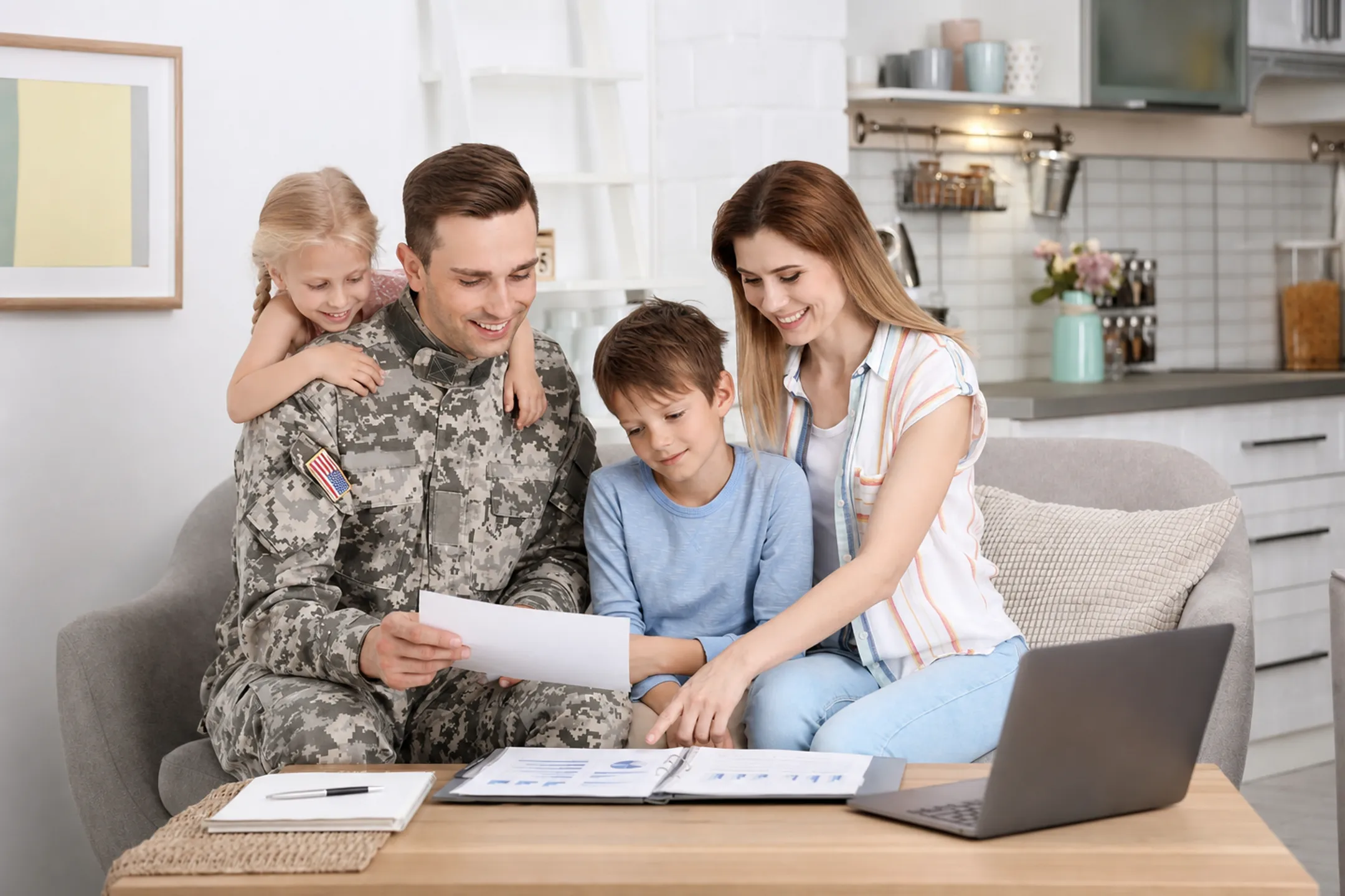 Military family reviewing home financing options together at home