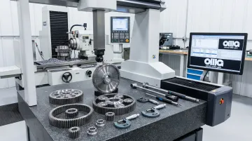 Precision planetary gear components and grinding equipment at Carnes-Miller Gear facility