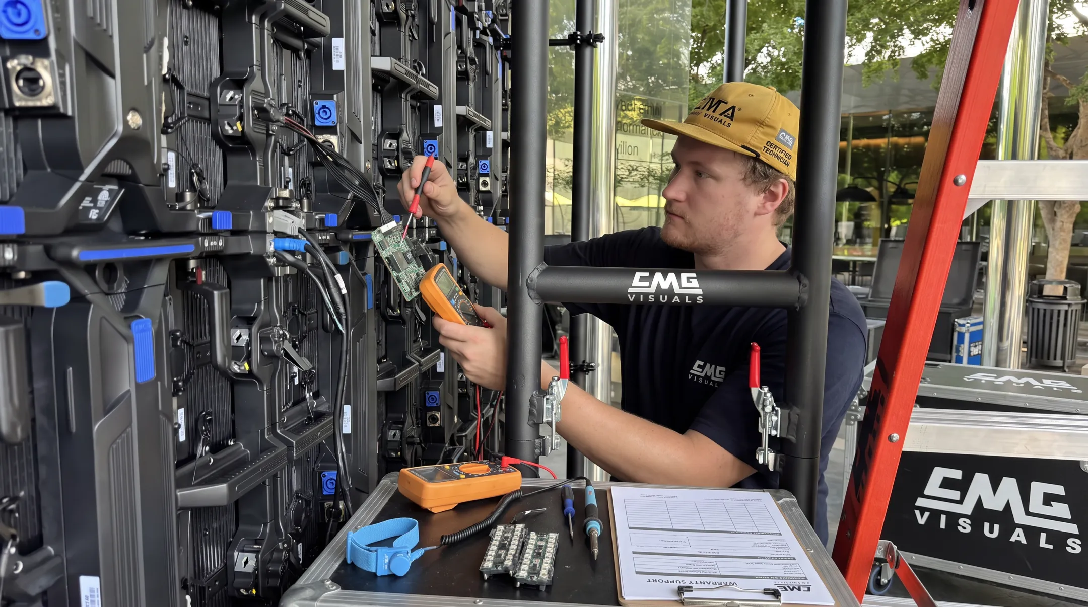 CMG Visuals technician repairing LED display module on-site