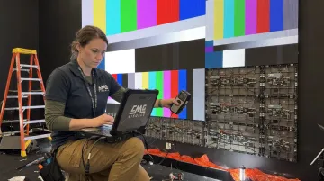 Certified technician calibrating LED video wall panels during installation