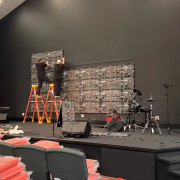 Technician calibrating a church LED video wall