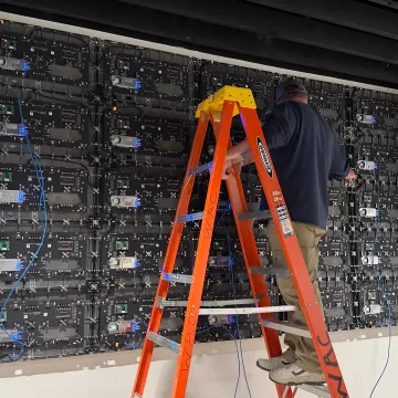 Technician calibrating a custom LED video wall