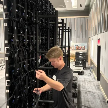 Technicians setting up an LED wall for an event