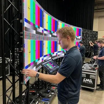 Technician aligning curved LED video wall panels