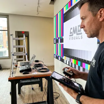 Technician calibrating a custom LED video wall