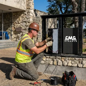 Technician installing outdoor LED church sign