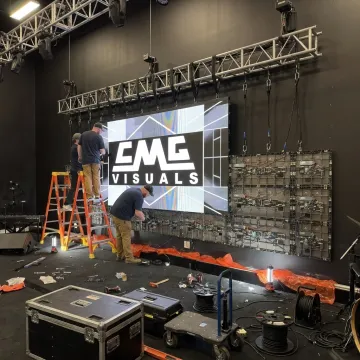 Technicians assembling an LED video wall for an event