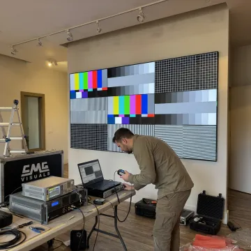 Technician calibrating an indoor LED video wall