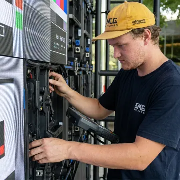 Technician calibrating outdoor LED display screen