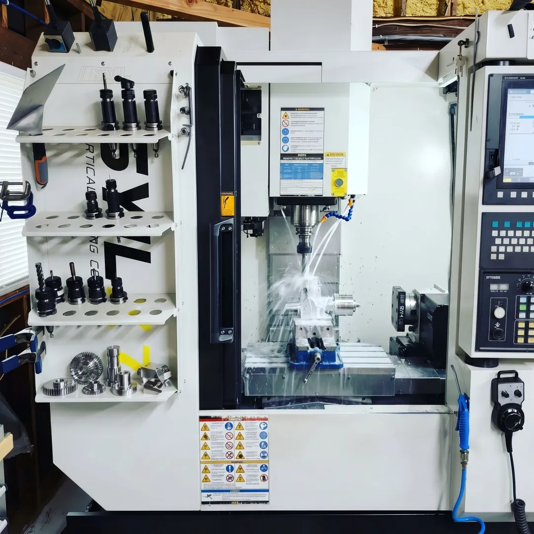 Technician reviewing precision machined components