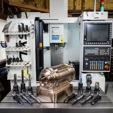 Precision machined metal component on CNC table