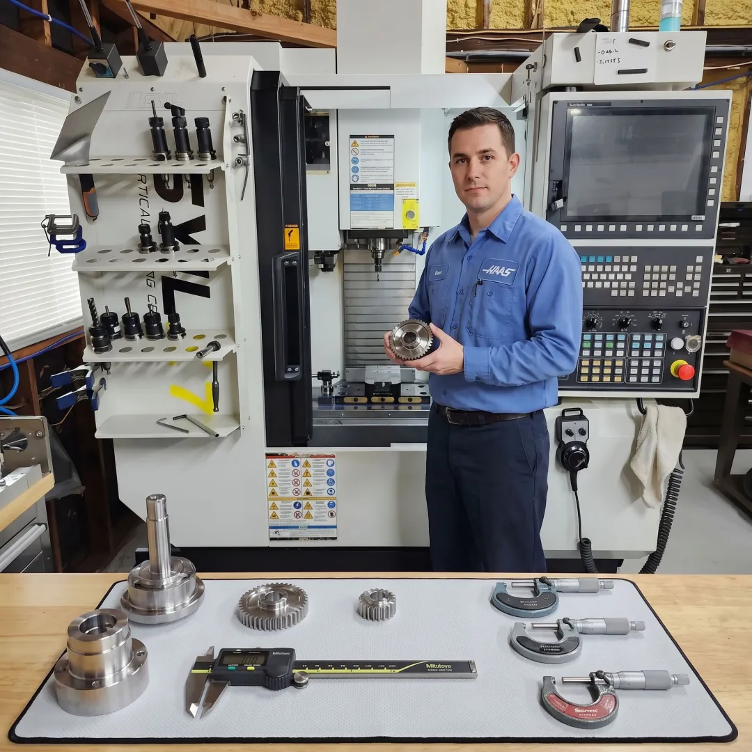 Technician reviewing machined metal parts