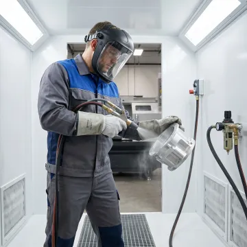 Technician bead blasting aluminum part