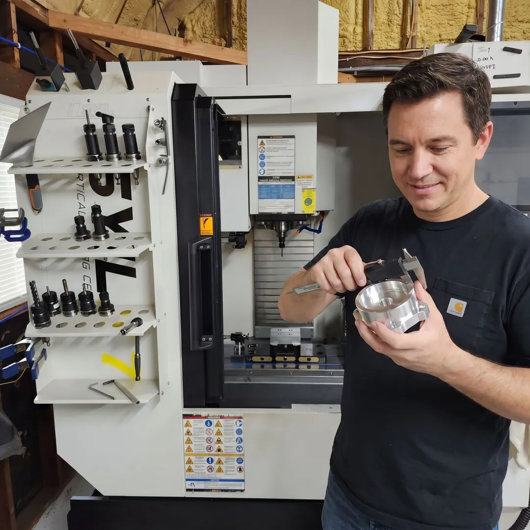 Technician inspecting a machined metal component