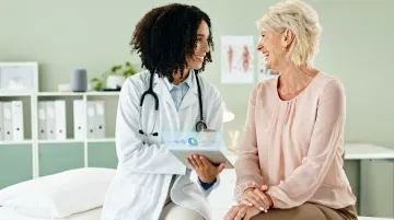 Physician using ambient AI documentation tool during patient consultation in clinic