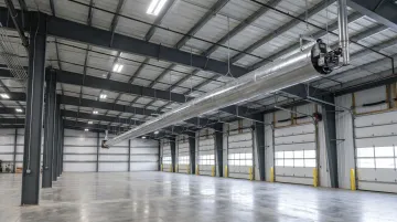 Industrial radiant tube heater ceiling-mounted in large warehouse or automotive facility