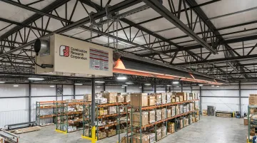 Combustion Research Corporation Reflect-O-Ray infrared tube heater installed in warehouse ceiling