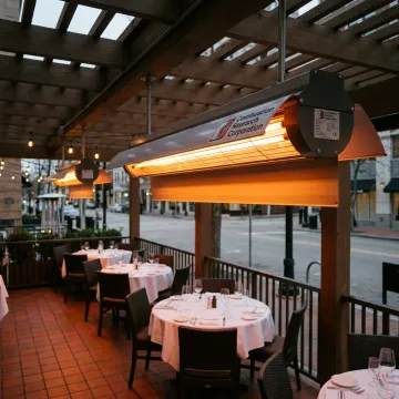 Commercial infrared patio heater above covered seating