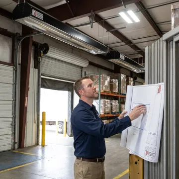 Engineer reviewing warehouse radiant heater plans