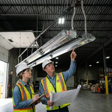 Technicians reviewing radiant tube heater installation layout