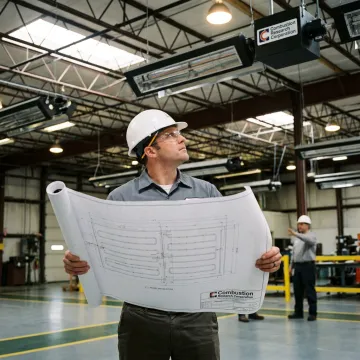 Engineer reviewing radiant tube heater plans