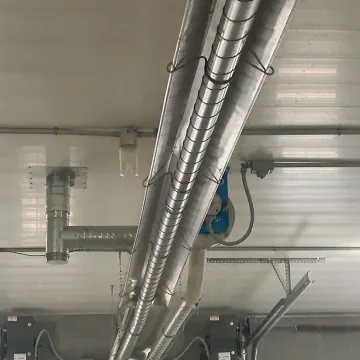 Technicians reviewing radiant tube heater installation layout