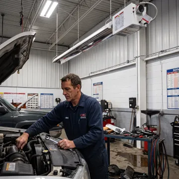 Technician working in a radiant-heated service bay