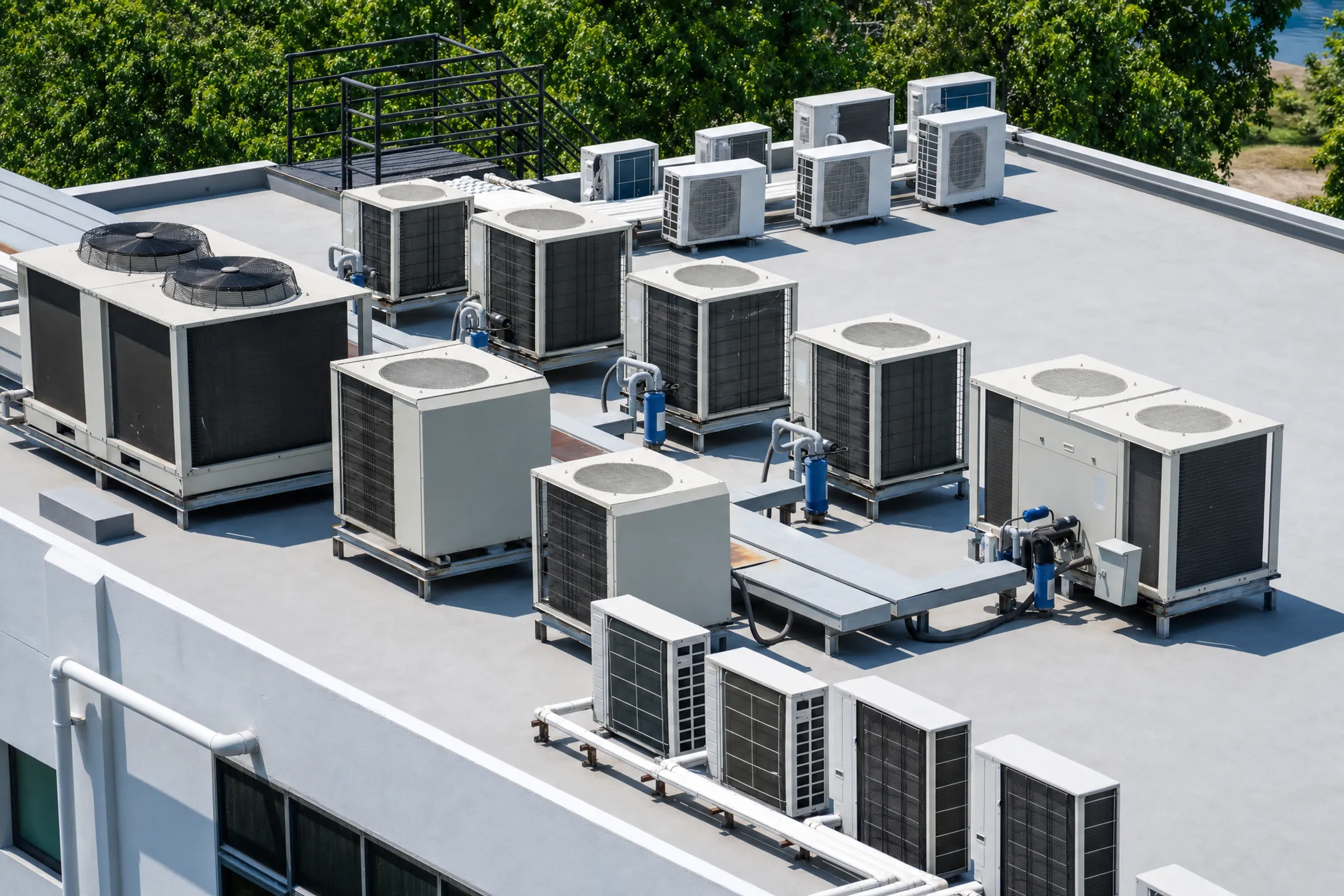Commercial rooftop HVAC units installed on large industrial building